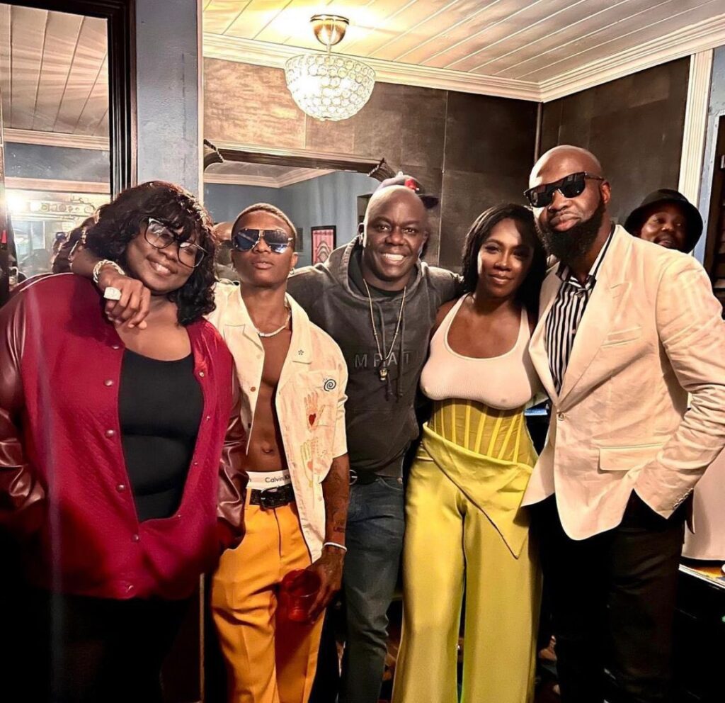 wizkid and tiwa in a group photo